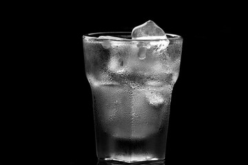 Close up of glass with ice cube as refreshing drink during summer