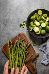 hands holding fresh asparagus, fresh green veggies, healthy cooking