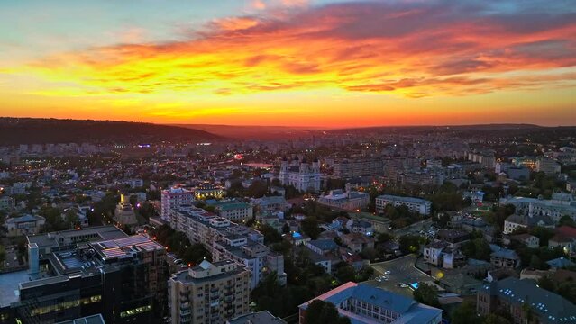 Aerial drone view of Iasi at sunset, Romania. Multiple historical and residential buildings, greenery