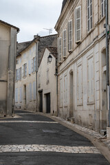 View on old streets and houses in Cognac white wine region, Charente, walking in town Cognac with strong spirits distillation industry, France