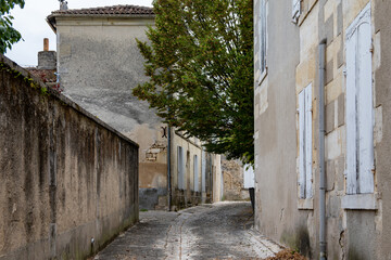 View on old streets and houses in Cognac white wine region, Charente, walking in town Cognac with...
