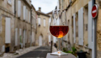 Tasting of cognac alcohol drink and view on old streets and houses in town Cognac, Grand Champagne,...