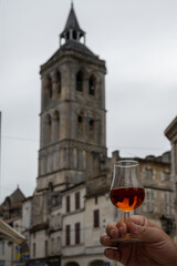 Tasting of cognac alcohol drink and view on old streets and houses in town Cognac, Grand Champagne,...