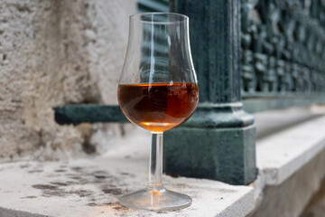 Tasting of cognac alcohol drink and view on old streets and houses in town Cognac, Grand Champagne,...