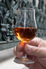 Tasting of cognac alcohol drink and view on old streets and houses in town Cognac, Grand Champagne, Charente, strong spirits distillation industry, France