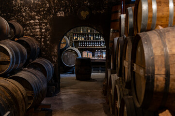 Aging process of cognac spirit in old French oak barrels in cellar in distillery in Cognac white wine region, Charente, Segonzac, Grand Champagne, France