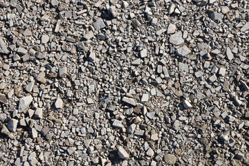 Background of shattered stony stones surface in mountain area. Flat texture with natural light