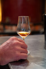 Tasting of cognac spirit aged in old French oak barrels in cellar in distillery in Cognac white wine region, Charente, Segonzac, Grand Champagne, France