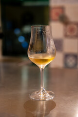 Tasting of cognac spirit aged in old French oak barrels in cellar in distillery in Cognac white wine region, Charente, Segonzac, Grand Champagne, France