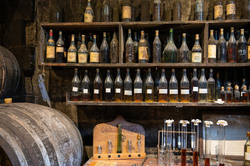 Blending process of cognac spirit and old French oak barrels in cellar in old distillery in Cognac...
