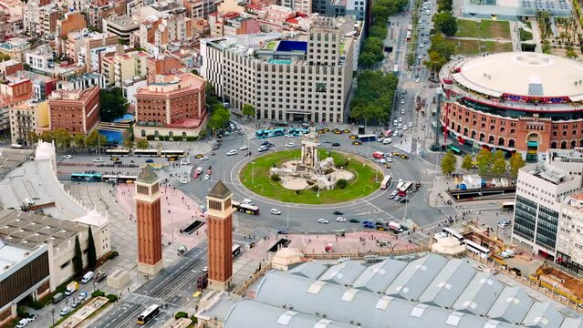 Aerial drone view of Plaza of Spain in Barcelona, Spain. Roundabout with moving cars, buildings