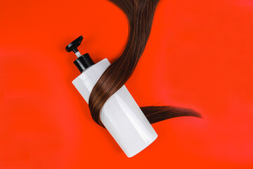 Hair shampoo in a white bottle on a red background. Brunette and hair balm. Promotional banner for...