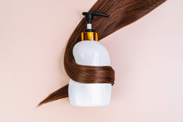 Hair shampoo in a white bottle on a beige background. Brunette and hair balm. Promotional banner...