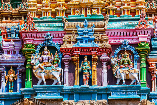 Shiva and Parvati on bull images. Sculptures on Hindu temple gopura tower. Meenakshi Temple, Madurai, Tamil Nadu, India
