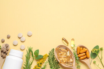 Different pills, herbs and flowers on light yellow background, flat lay with space for text....
