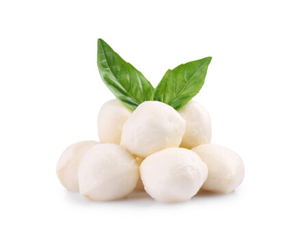 Tasty mozzarella balls and basil leaves isolated on white