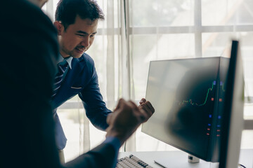 Stock trader in front of computer Businessman on monitor screen with cryptocurrency graph that...