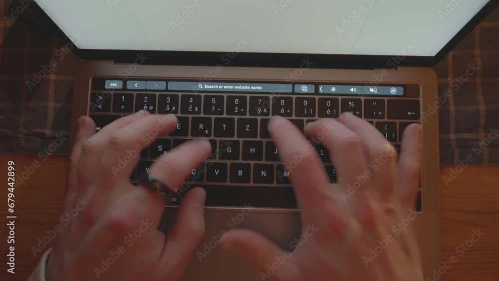 Poster top down shot of laptop keyboard layout while man type on it ring on finger