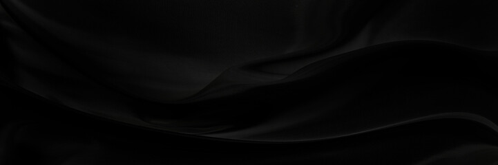 Black gray satin dark fabric texture luxurious shiny that is abstract silk cloth panorama background with patterns soft waves blur beautiful.