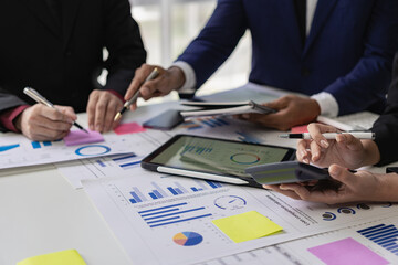 Businessmen discuss charts and graphs showing the results of successful teamwork. Business meeting closed to discuss market situation Business finance concept, close-up image