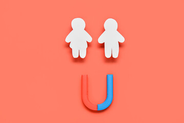 Couple made of paper with magnet on red background