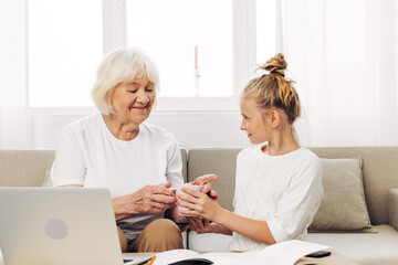 Bonding togetherness hugging smiling granddaughter laptop grandmother family selfie child