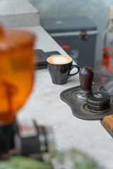 a cup of latte art in a coffee shop. a barista makes latte art