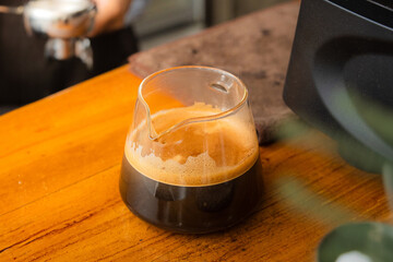 making a big shot of espresso at the coffee shop. a cup of espresso coffee