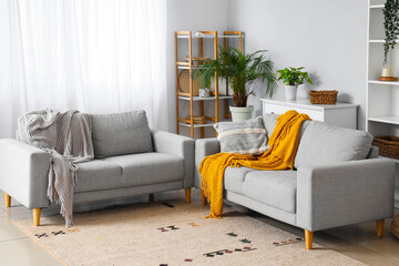 Interior of modern living room with grey sofas