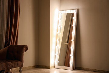 Glowing mirror in dark makeup room