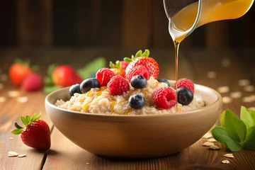 Foto op Plexiglas A close-up shot of a hearty bowl of Quaker oats, garnished with fresh fruits and a drizzle of honey, sitting on a rustic wooden table bathed in the morning sunlight © aicandy