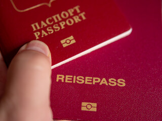 Russian Federation and German Passports Held Together - obrazy, fototapety, plakaty