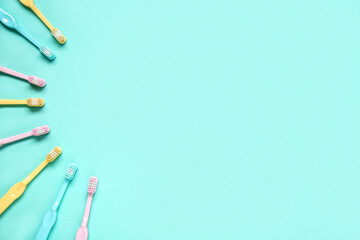 Colorful plastic toothbrushes on color background.