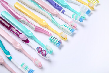 Colorful plastic toothbrushes on white background.