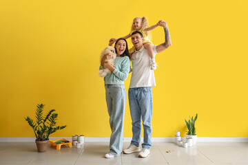 Happy family during repair of their new house - obrazy, fototapety, plakaty