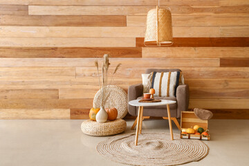 Stylish interior of modern living room with beautiful autumn decor