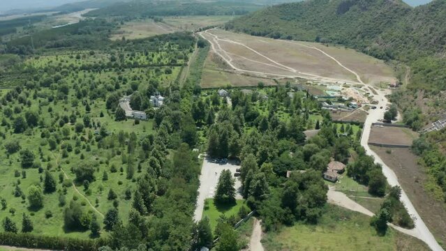 Pull-in drone shot of the St. Petka Church with the cross sculpture in Rupite, Bulgaria in honor of the volcano eruption victims as ordered by Bulgarian prophetess Baba Vanga.
