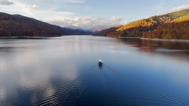 Aerial drone view of Vidraru Lake and Fagaras Mountains. Transfagarasan, Romania. Late autumn season