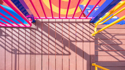 Sunlight and shadow on surface of different walkway level of modern outdoors playground equipment...