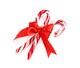 Christmas candy canes with bow on white background