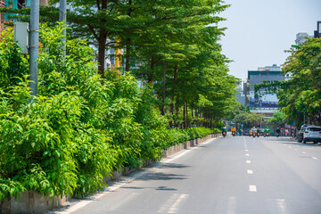 Hanoi street with green tree lines on Kim Ma street
