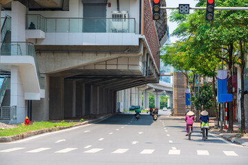 Hanoi street traffic with elevated train station on Hoang Cau street, Vietnam