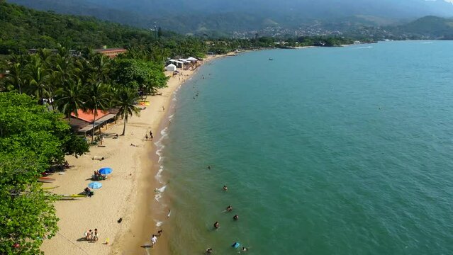 Aerial shot drone flies low over Pereque Beach on Ilhabela