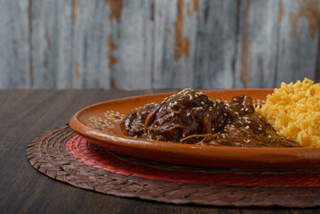 Mole, typical Mexican food. Traditional Mexican dish served in a clay dish.
