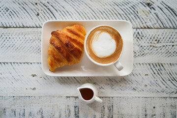 Breakfast hot latte and croissant