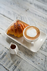 Breakfast hot latte and croissant