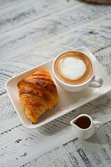 Breakfast hot latte and croissant