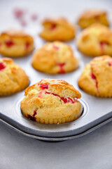 Muffins with red currants in the form for baking
