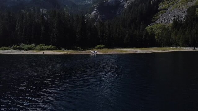 Beautiful Mountain Lake with Seaplane on the Wilderness Beach AERIAL