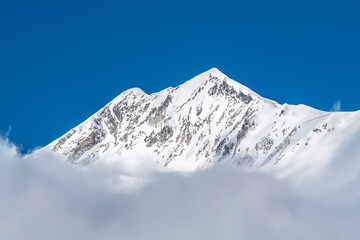 Fototapeta na wymiar Mountain landscape with snow and clear blue sky. Caucasus, Russia